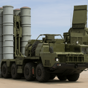 A military S-400 missile defense system vehicle carrying four vertical missile tubes and radar equipment on an eight-wheeled transporter.