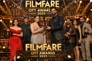 Group of actors and filmmakers holding Filmfare OTT Awards trophies on a golden-lit stage during the 2025 awards ceremony.